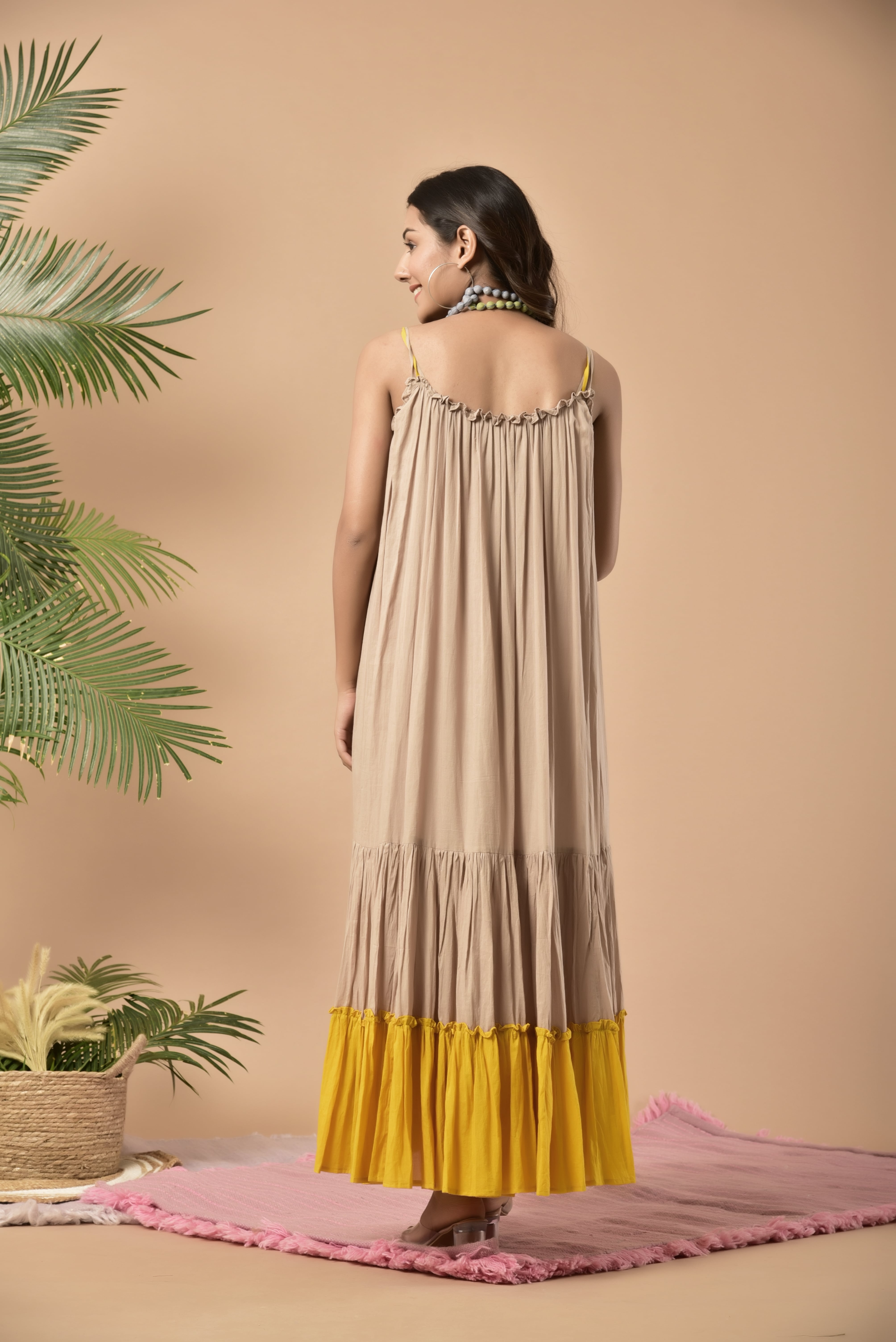 Beige and yellow mulmul anchor spaghetti dress with anchor hand work on the first panel layered ankle length dress and the last layer is yellow