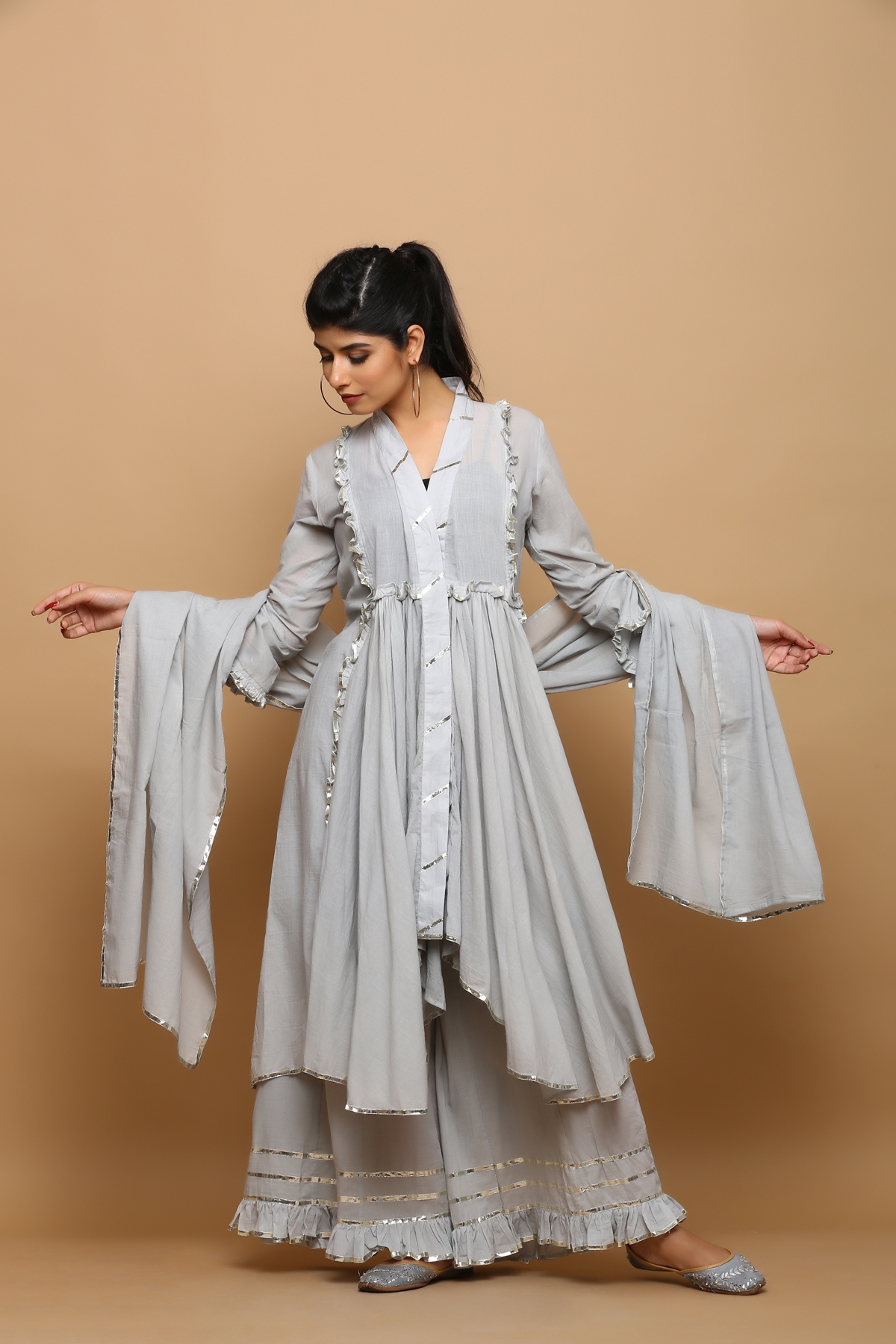 Grey a- symmetrical mulmul kurta with flarred palazzo and dupatta and it comes with inner
