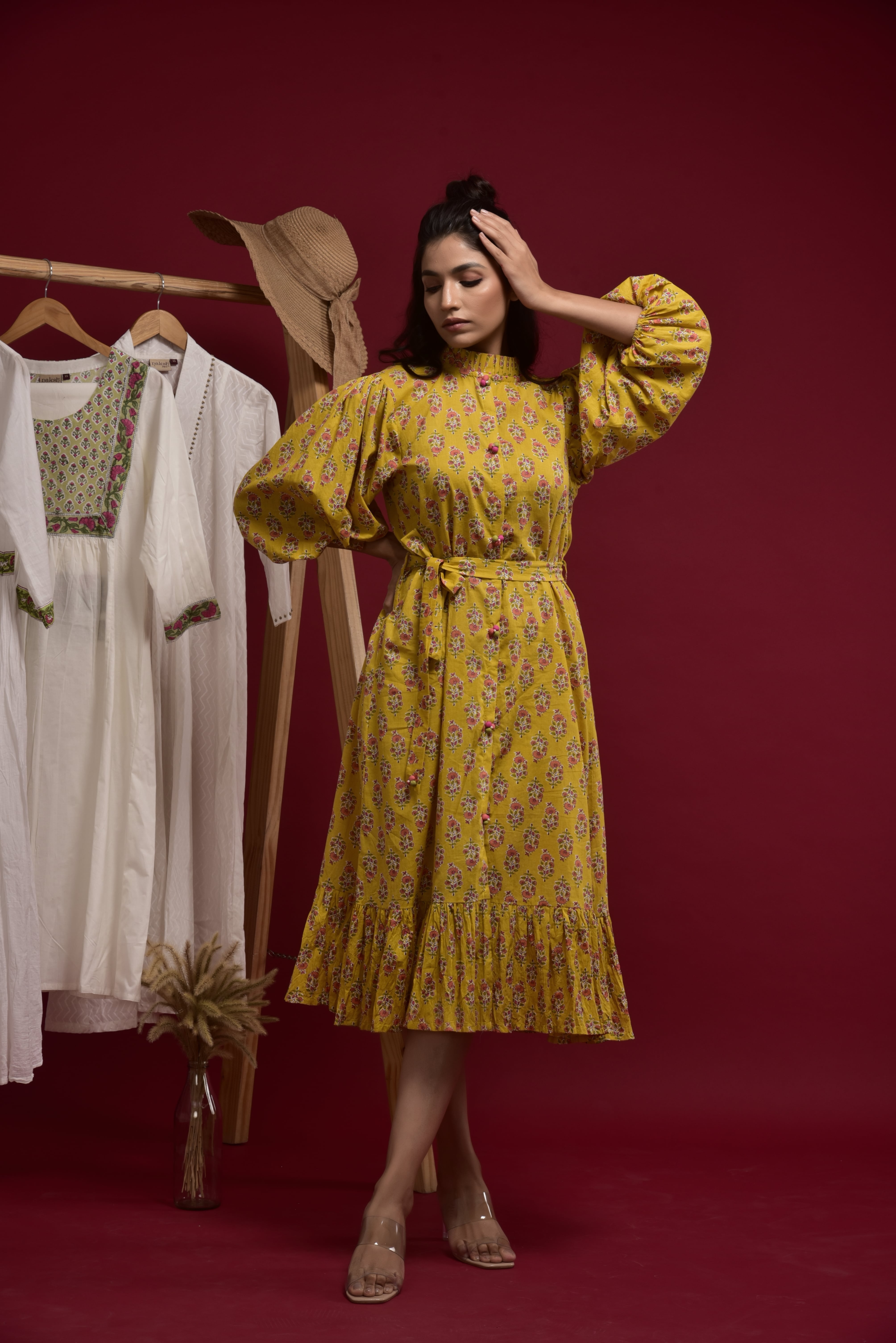 Yellow printed dress with fabric buttons on the front