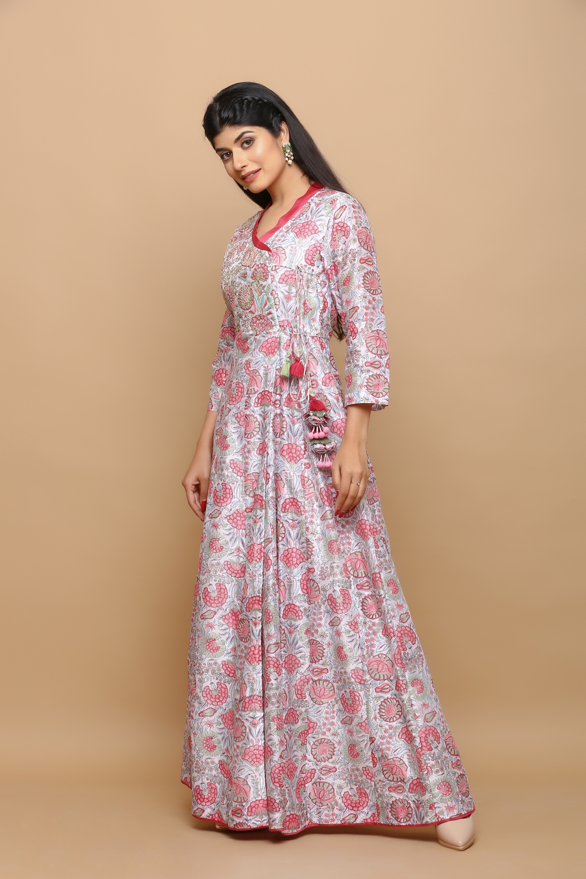 White block printed jaal chanderi angrakha anarkali kurta with handwork on the yoke and tassels on the side and is fully lined .