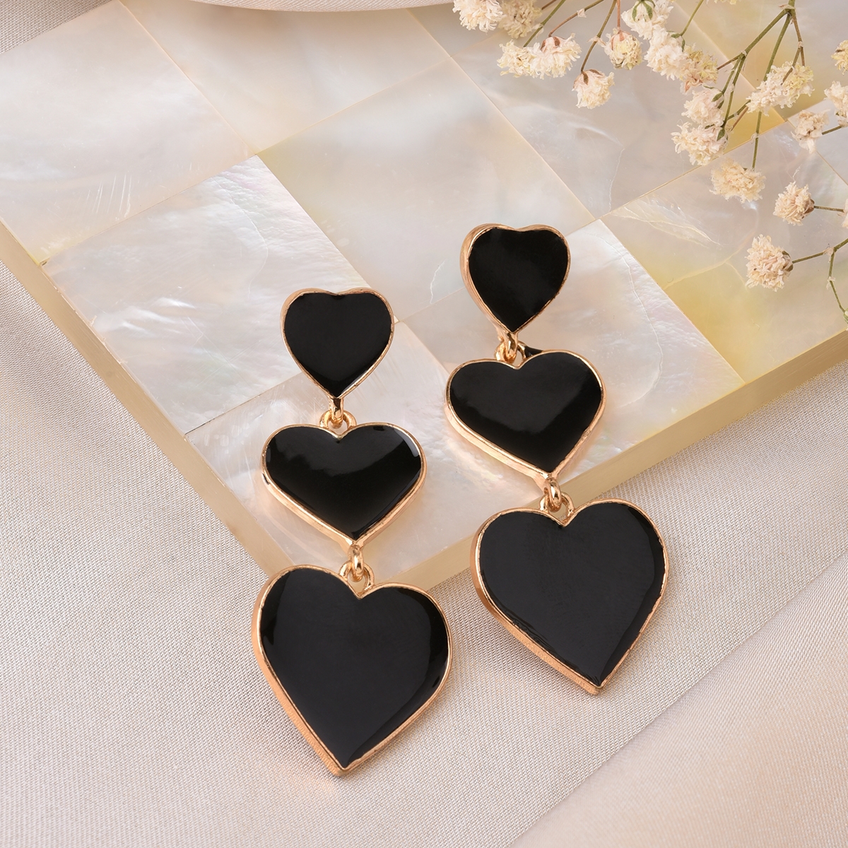 Lilly & Sparkle Gold Toned Black Enameled Triple Heart Dangler Earrings